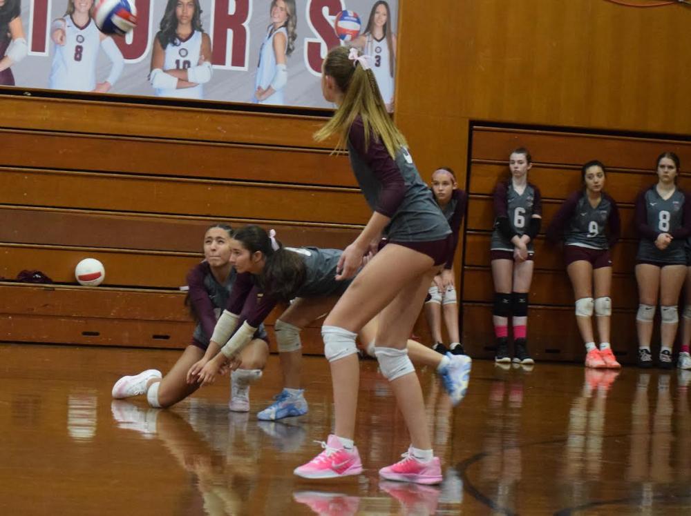 Olivia Moniz and Annie Hagan go for the ball. vball