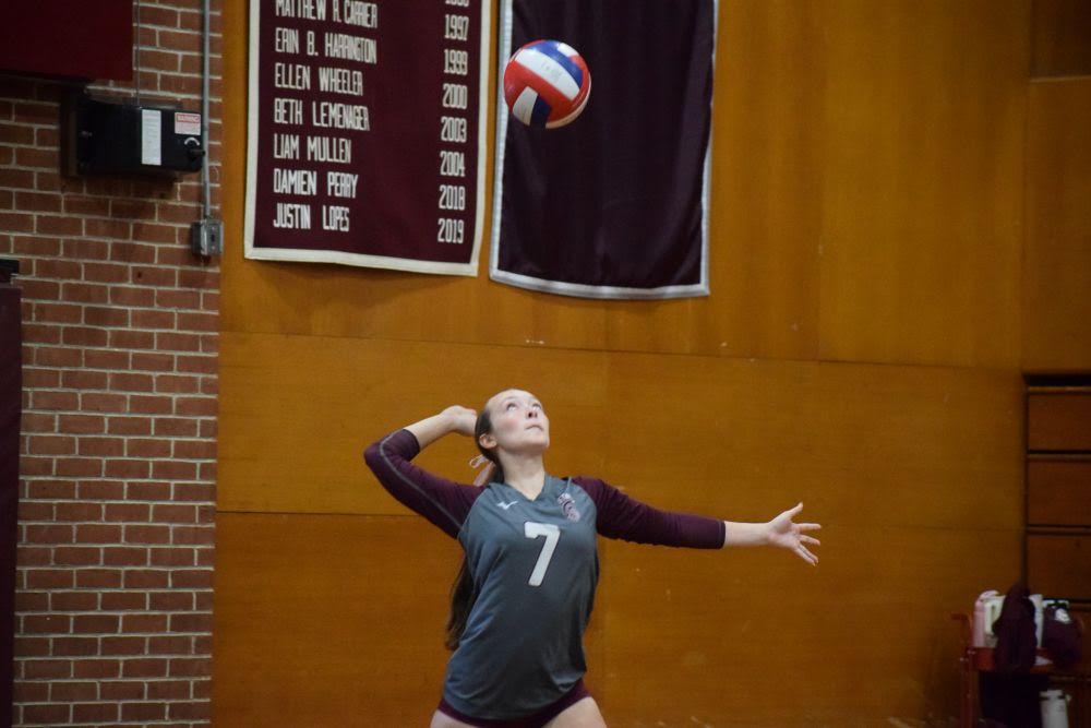 Olivia Lacaponi serves the ball. vball