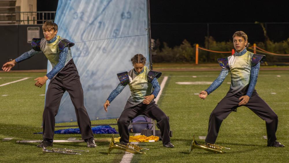 Marching band members dance as if they are in rough waters. s