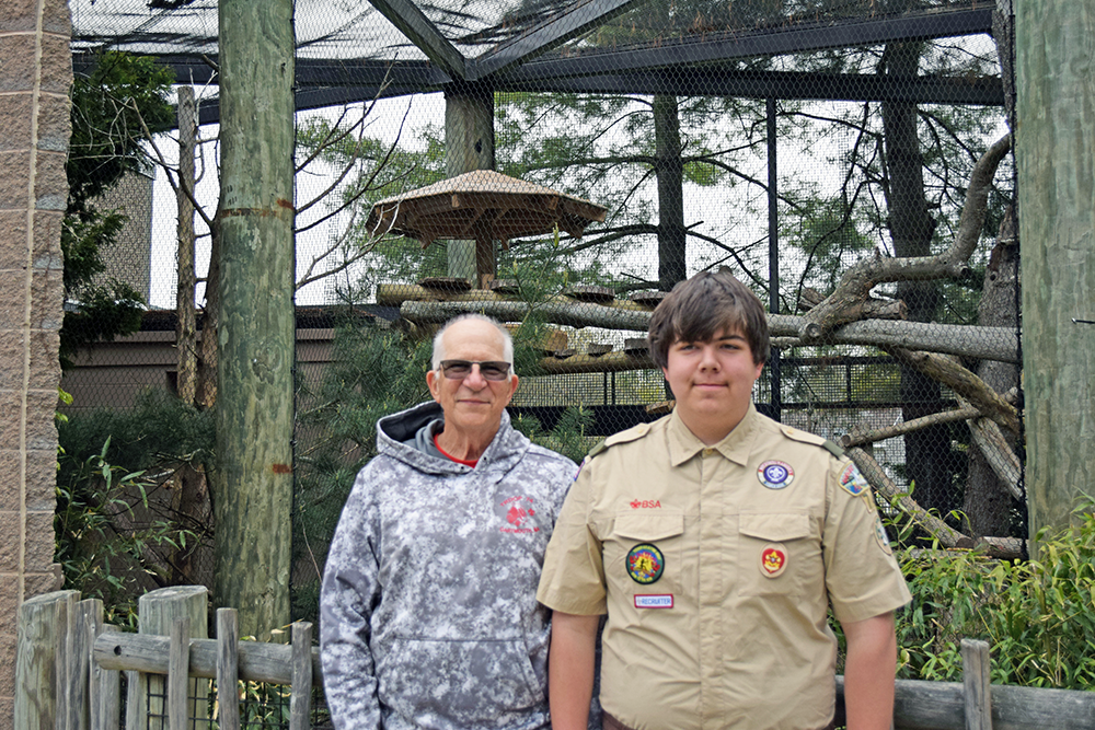 Zane and Kevin Moriarty pose in front of the sun cover they built for Jacob the red panda. Photos by Kat Sheridan