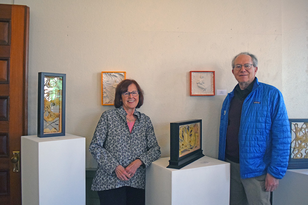 Susan Medyn and David Formanek pose in front of some of their art. Photos by Kat Sheridan