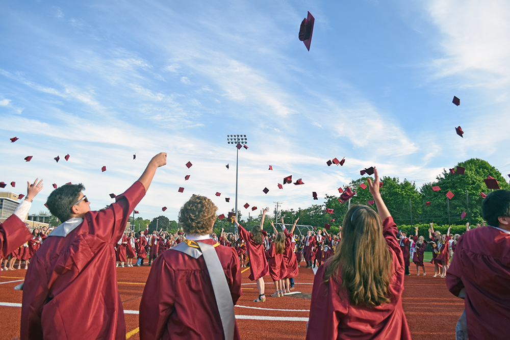 The students toss their caps in the air. Photos by Kat Sheridan