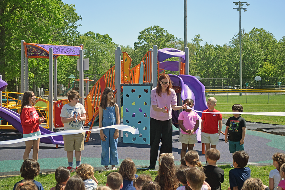 Audra Thomas cuts the ribbon with (right to left) Lenox Porta from kindergarten, Zoe Francis from first grade, Josie Oliver from second grade, Lillian Cabral from third grade, Atticus Folger from fourth grade and Mila DeBarros from fifth grade. Photos by Kat Sheridan.