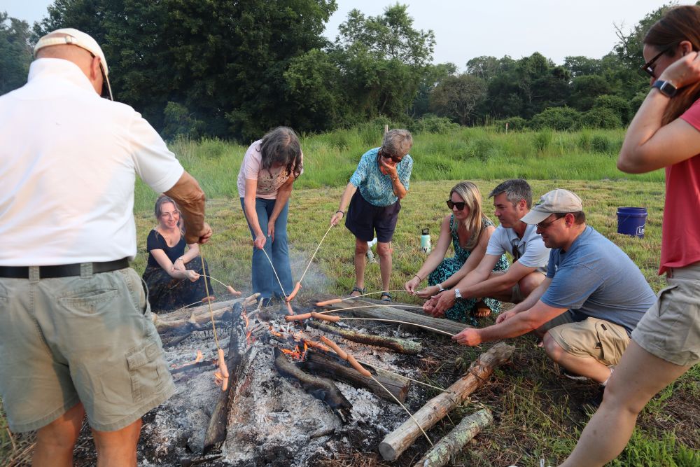 A group roasts hot dogs around the fire. Photos by Kat Sheridan
