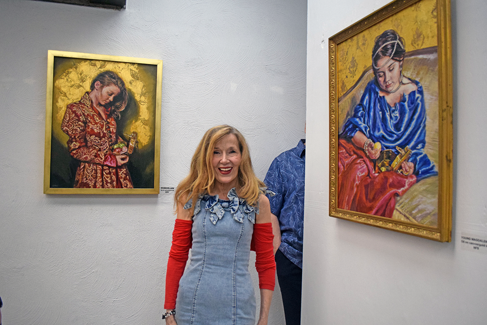 Deborah Macy poses with a couple of her paintings. Photos by Kat Sheridan