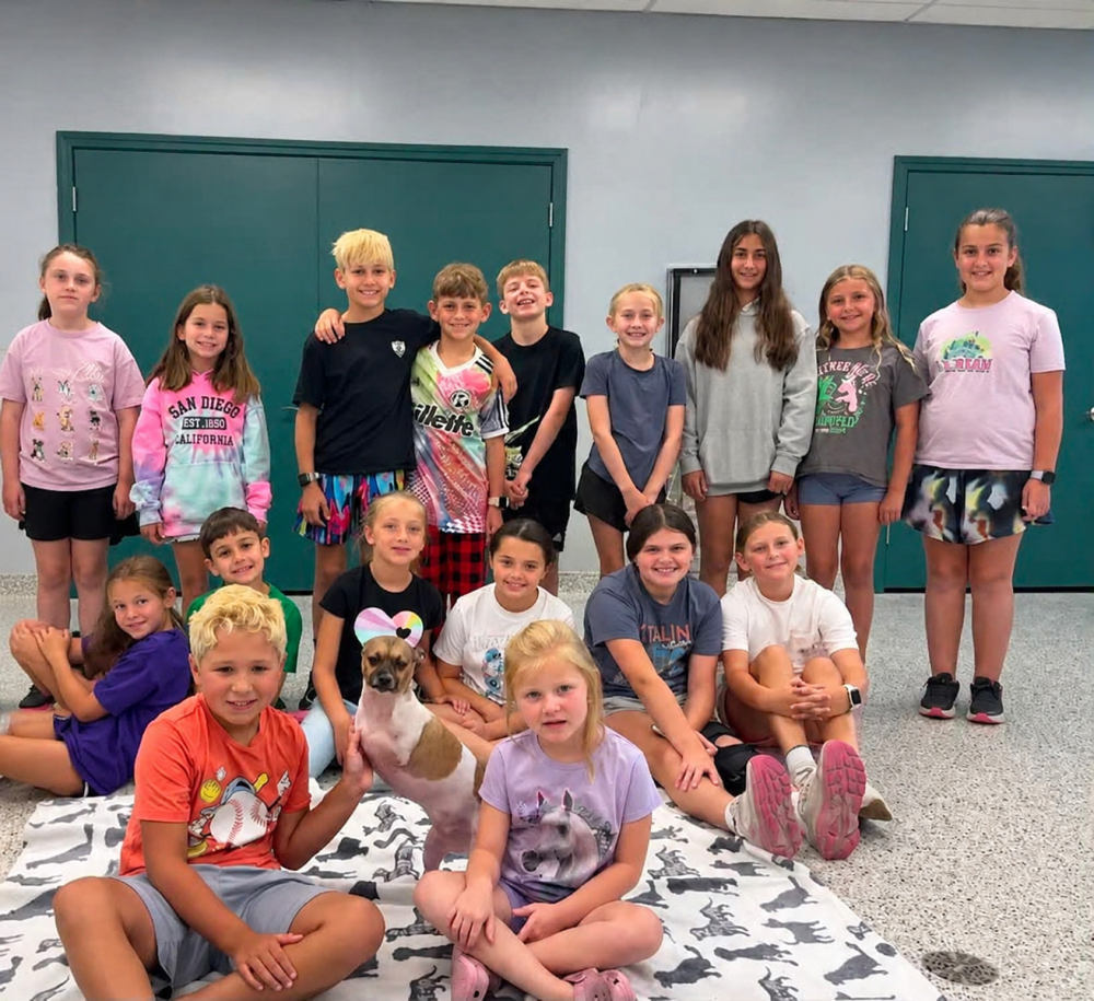 The group poses with Joey, the two-legged dog. Source: Traci Martin