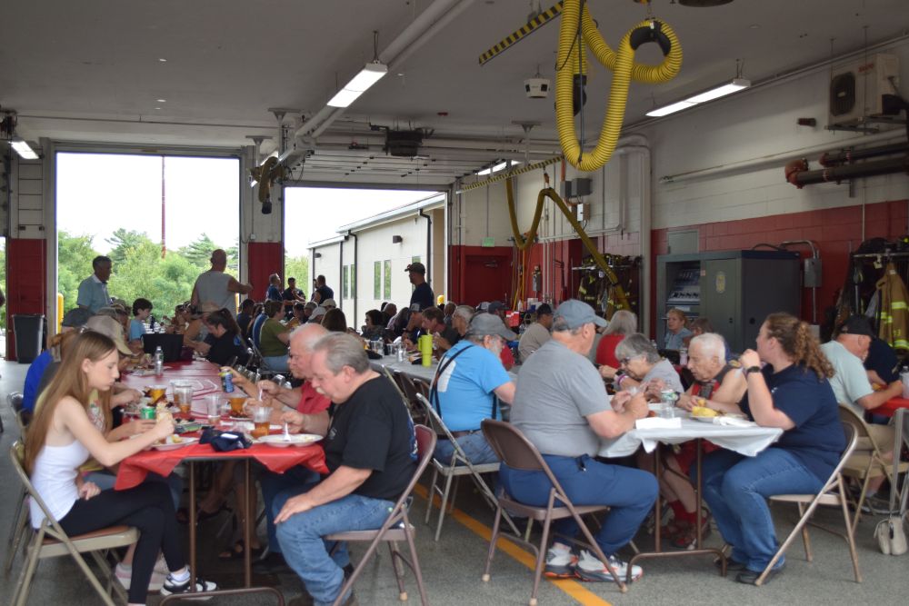 The crowd at Fire District 3 enjoys the pig roast. Photos by Kat Sheridan
