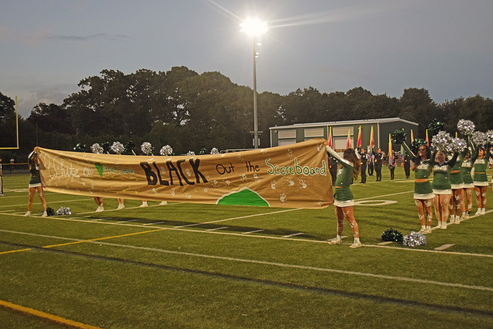 The banner stating the motto of the game, "White out the stands, black out the score board." Photos by Kat Sheridan