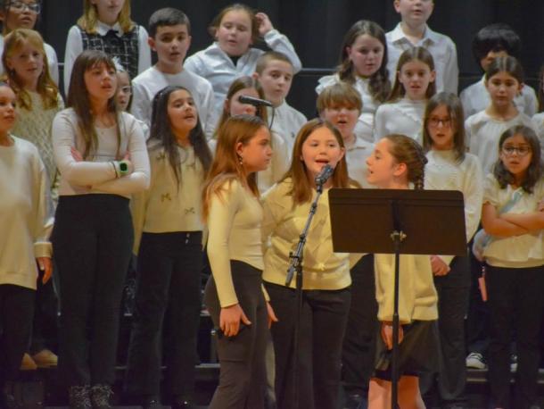 Three girls from the Potter School sing a solo during the concert. Photo by Kat Sheridan