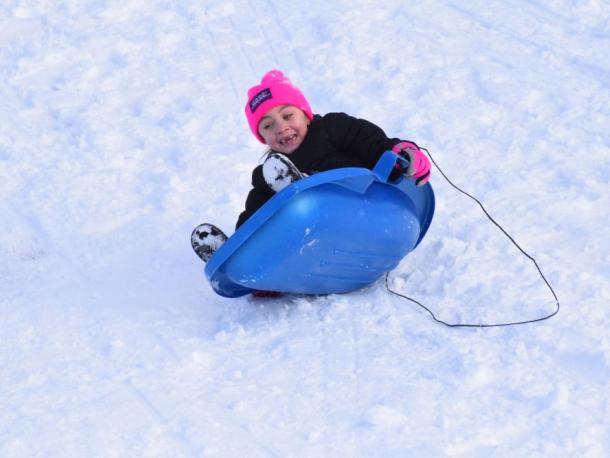 Avarey Landgrof, 7, tips over in her sled.