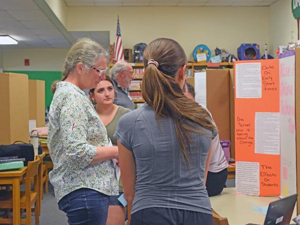 Students present their project to Elizabeth Coughlin. 