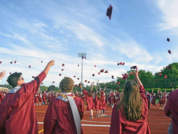 The students toss their caps in the air. Photos by Kat Sheridan