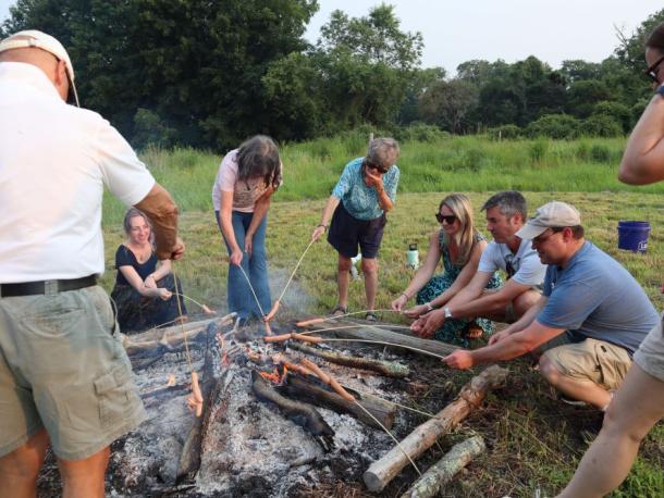 A group roasts hot dogs around the fire. Photos by Kat Sheridan
