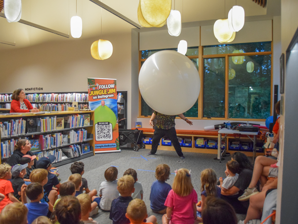 Jungle Jim climbing into the balloon to show the kids the dinosaur. Photos by Kat Sheridan