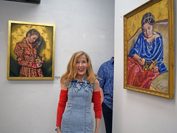 Deborah Macy poses with a couple of her paintings. Photos by Kat Sheridan