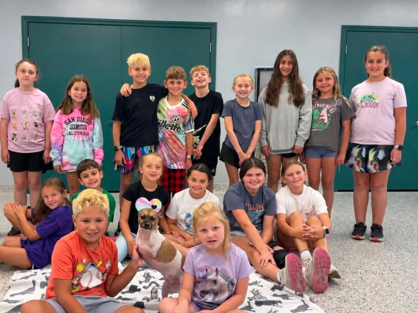 The group poses with Joey, the two-legged dog. Source: Traci Martin