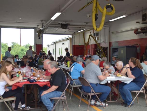 The crowd at Fire District 3 enjoys the pig roast. Photos by Kat Sheridan