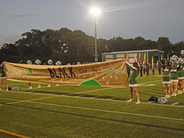 The banner stating the motto of the game, "White out the stands, black out the score board." Photos by Kat Sheridan