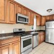 Wood kitchen cabinets with stainless refrigerator, microwave and range at 17 Beeden Road, Westport, MA