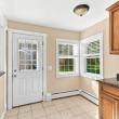 Kitchen with granite counters, a back door and two windows in the apartment at 17 Beeden Road, Westport, MA