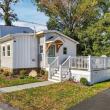 Front of 226 Sanford Road in North Westport, MA: a two-story home with board and batten siding and a front deck