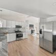 Kitchen with stainless appliances, open to the living area, at 226 Sanford Road in Westport, MA