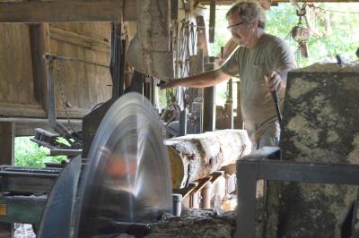 Jack Delano slices into a log at Joseph K. Delano Sawmill. The circular saw is about 50 inches across and has 40 teeth. BY SETH THOMAS