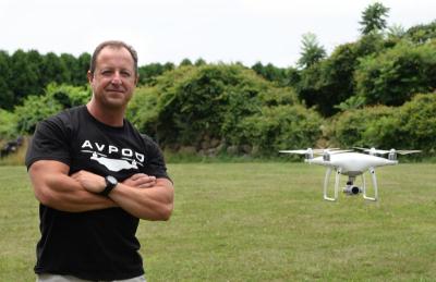 Anthony Franco poses for a photo next to his drone as it hovers nearby. BY DOUGLAS MCCULLOCH