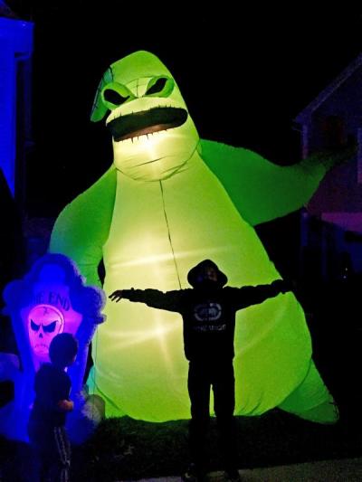 Grayson (3) and Cole White (7) in front of their favorite inflatables.