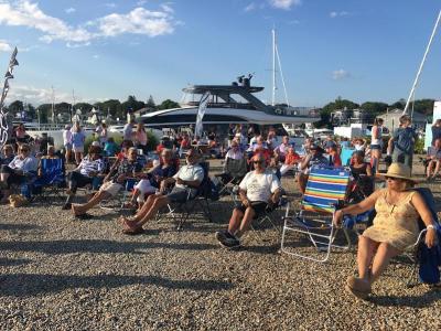 Participants savor a perfect summer evening to listen to the band.