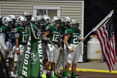 Jackson Hart and his team carry flags out onto the field. Source: Jackson Hart
