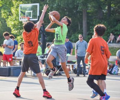 Preston Casteel attempts a basket during a Burgo Basketball league game this summer.