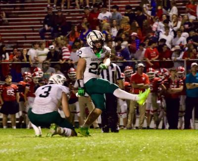 Michael Hauck kicks a field goal while Aidan Gendron holds. 