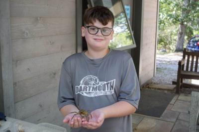 Sawyer Bond, 10, holds a local spider crab.