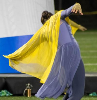 A member of the color guard dances. f