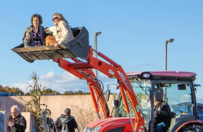 Two attendees at Running Brook Vineyard's harvest festival take a ride in a tractor on Sunday, Oct. 26. Photo by Abby Van Selous T