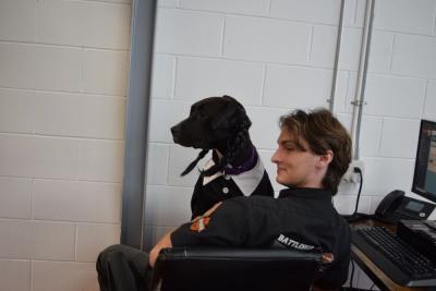 Luci sits in Sam Martin's lap.