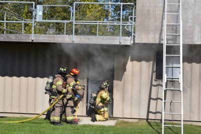 Firefighters demonstrate how they put out a house fire.