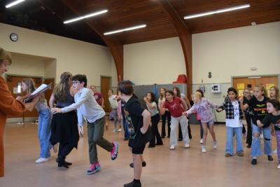 Kids practice the choreography. 