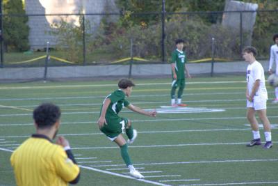 A teammate kicks the ball back into play. 