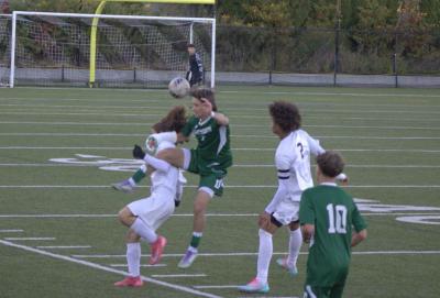 Logan Stott tries to keep the ball away from an opposing player. 