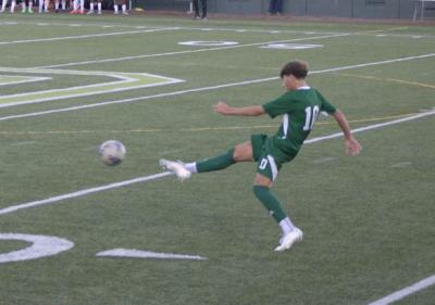 Caleb DaSilva kicks the ball. 