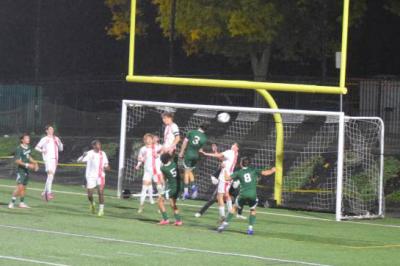 Landon Raposa jumps to headbutt the ball. 