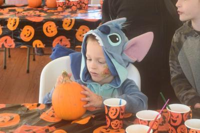 Josia Raposa paints a pumpkin.  Josia Raposa paints a pumpkin.