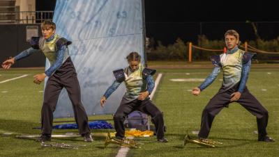 Marching band members dance as if they are in rough waters. s