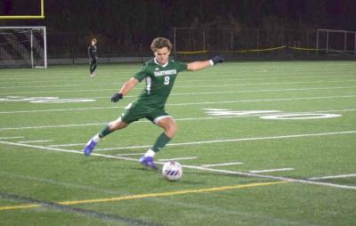 Carter Brennan kicks the ball back into play.