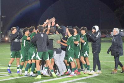 The team celebrates with their trophy.