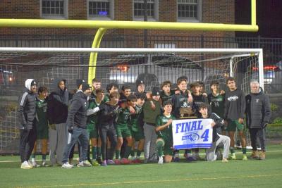 The Dartmouth High School boys soccer team poses with their Final 4 trophy and banner. Photos by Kat Sheridan