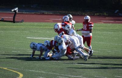 Dartmouth players tackle a New Bedford football player. 