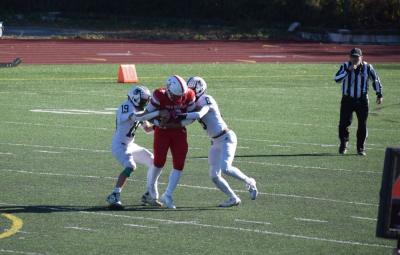 Dartmouth players start to take a New Bedford player. 